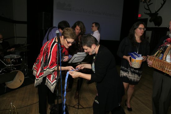 Monica Pollock checking Laurie Brongo's bucket raffle tickets.